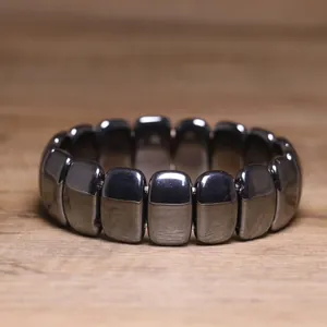 Detailed view of polished rectangular black hematite beads on an elastic stretch bracelet