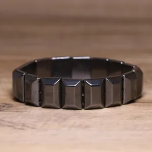 Macro detail of a high-quality faceted black hematite stone elastic bead bracelet