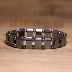 Detailed view of a dark grey metallic hematite magnetic therapy elastic bracelet.
