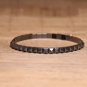 Detailed macro view of a black hematite elastic bracelet with pyramid stud design