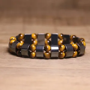 Close-up detail of hematite and yellow tiger's eye stone beaded stretch bracelet