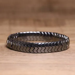 Detailed macro view of black hematite chevron-shaped links on a stylish elastic bracelet.