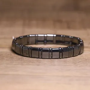 Detailed close-up showing the metallic sheen of a dark grey hematite stretch bracelet