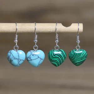 Close-up detail view of heart-shaped turquoise and malachite stone dangle earrings with hooks