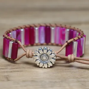 Close-up of handmade pink agate tube bracelet featuring a sunflower metal clasp
