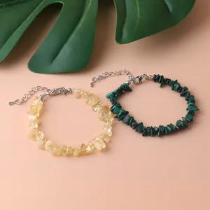 Macro view of natural irregular yellow and green crystal bead bracelets with silver clasps
