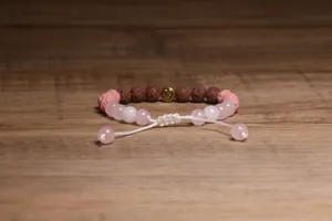 Gedetailleerde opname van een handgemaakte armband van lavasteen en rozenkwarts