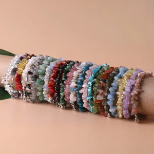 Assorted natural crystal irregular chip bracelets displayed on a kraft paper roll