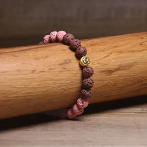 Handgemaakte natuurlijke lavasteen kralen armband met roze en bruine kralen en Om-symbool bedel
