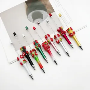 Detailed view of Christmas DIY beaded pens with festive ornaments and sugar texture