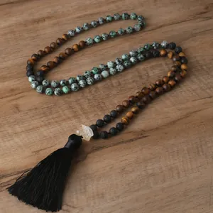 Detail view of handmade natural stone beaded necklace with a black tassel accent.