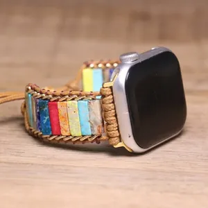 Detail view of colorful emperor stone braided watch band with gold chain accents