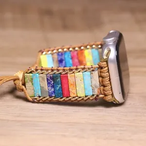Close-up of colorful Bohemian style watch strap with emperor stones and gold chain detail