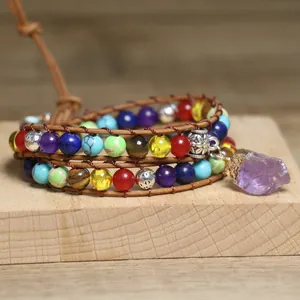 Close-up of a handmade boho wrap bracelet with natural amethyst and chakra beads