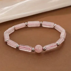Close-up of pink crystal energy bracelet with rectangular beads and silver accents