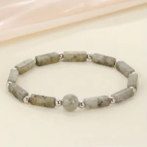 Close-up detail of natural grey stone energy bracelet with metallic spacer beads