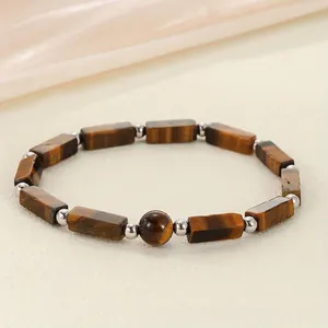 Macro view of a natural tiger eye stone bracelet with rectangular and round beads