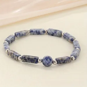 Macro detail of blue marble sodalite stone beads and silver spacers bracelet