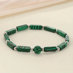 Detailed macro view of green malachite style rectangular stone beaded energy bracelet
