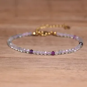 Close-up detail of colorful faceted natural tourmaline beads on a delicate bracelet