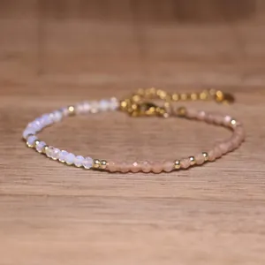Close-up detail of handmade beaded bracelet with faceted natural stones and gold accents
