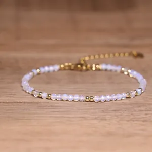 Detailed macro view of a handmade beaded bracelet with opalite beads and gold accents