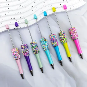 Close-up of DIY beadable pens with colorful sprinkle decoration in various pastel colors.