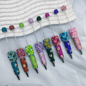 Detailed view of luxury floral rhinestone beaded pens in various vibrant colors and designs