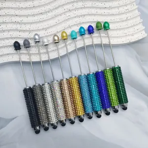 Detailed close-up of colorful rhinestone-encrusted stylus pens for touch screens.
