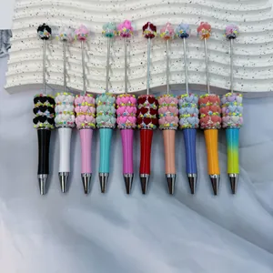 Ten colorful heart beaded ballpoint pens in macaron and candy colors on white tray