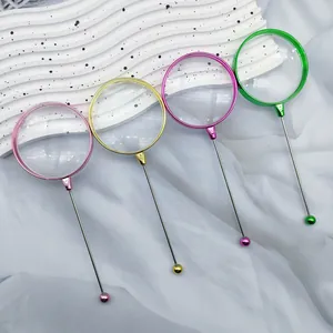 Detail view of multi-colored electroplated DIY beadable handheld magnifying glasses