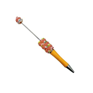 Handmade DIY heart-shaped beaded ballpoint pen in macaron candy yellow and pink colors
