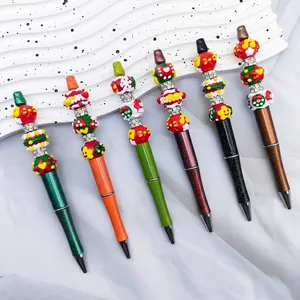 Set of six Christmas themed beaded ballpoint pens with festive hand-painted charms