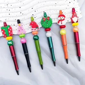 Assorted Christmas beaded ballpoint pens with Santa and snowman toppers for gifts.