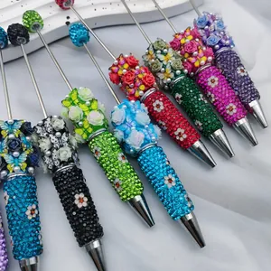 Luxury handmade beaded pens with colorful 3D roses and sparkling rhinestone barrels.