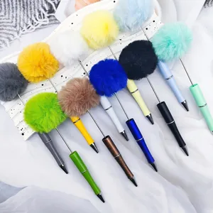Detailed view of colorful pom pom pens with fluffy tops and sleek metallic stems