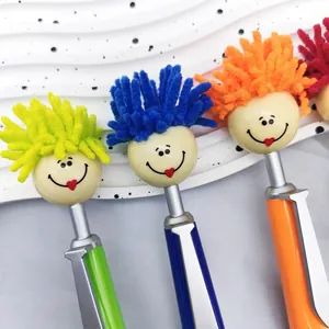 Detail of colorful ballpoint pens with plush smiley doll heads and stylus tip