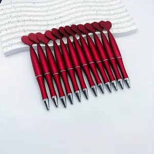 Set of 12 red heart-shaped twist ballpoint pens displayed on a white wave stand.
