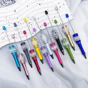 Collection of decorative DIY beaded pens featuring lace bows and sparkling rhinestone accents