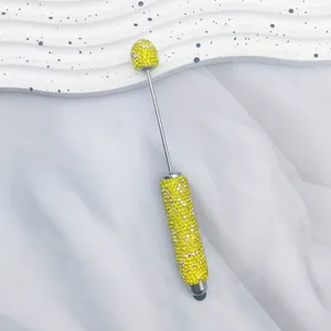 Detailed macro view of a luxury yellow rhinestone stylus pen with dual writing mode
