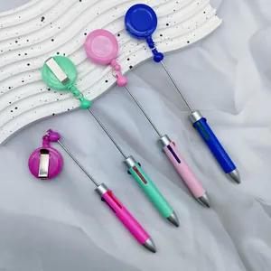 Retractable multi-color ballpoint pens with badge reel clip on white background