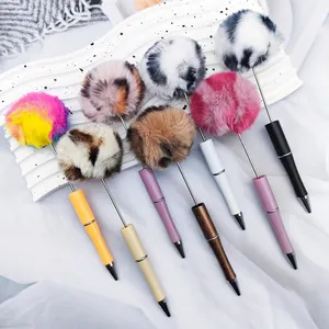 Cute colorful pom-pom ballpoint pens featuring leopard print and gradient fluffy tops.