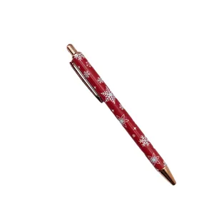 Festive red Christmas ballpoint pen with snowflake patterns and rose gold metal accents
