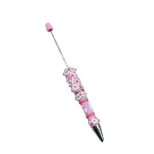Creative DIY beadable pen with pink decoden cream glue decoration for unique crafts.