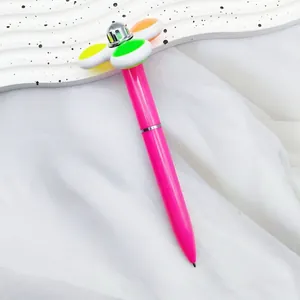 Pink fidget spinner ballpoint pen featuring a colorful rotating flower head design
