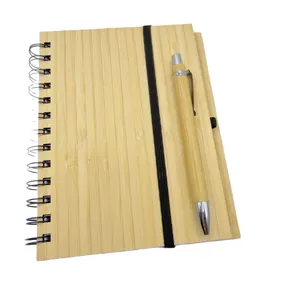 Eco-friendly bamboo cover spiral notebook with matching pen set for business journaling.