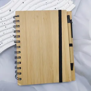 Detail of eco-friendly bamboo cover notebook with elastic band and matching pen