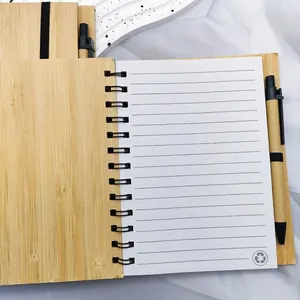 Eco-friendly 14x18cm bamboo spiral notebook with lined paper and a matching pen.
