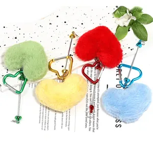 Detailed view of four colorful heart-shaped plush keychains with carabiners.
