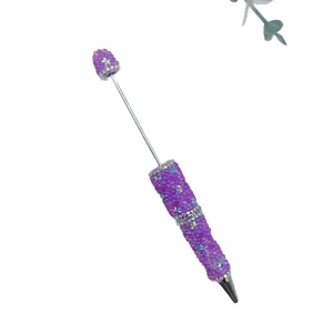 Elegant purple beaded ballpoint pen with sparkling rhinestone star accents and a white background